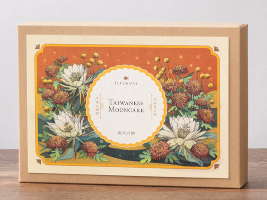 Taiwanese mooncake packaging with floral design on a wooden surface