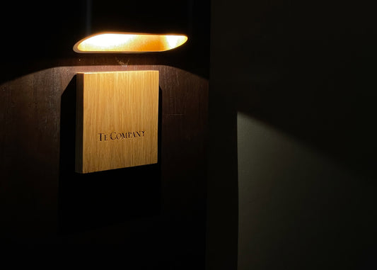 Te Company sign illuminated by soft light.