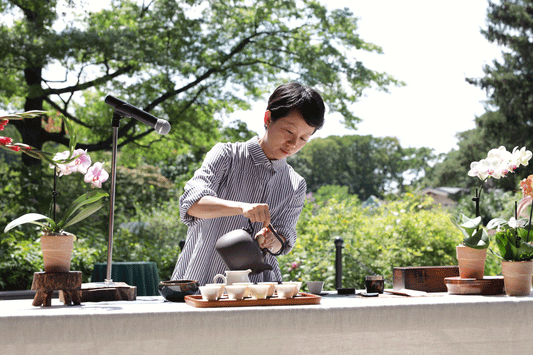 Elena Liao pouring tea Queens Botanical Garnden.