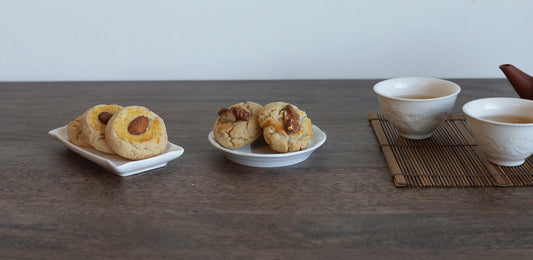 Almond and walnut cookies with tea set on table.