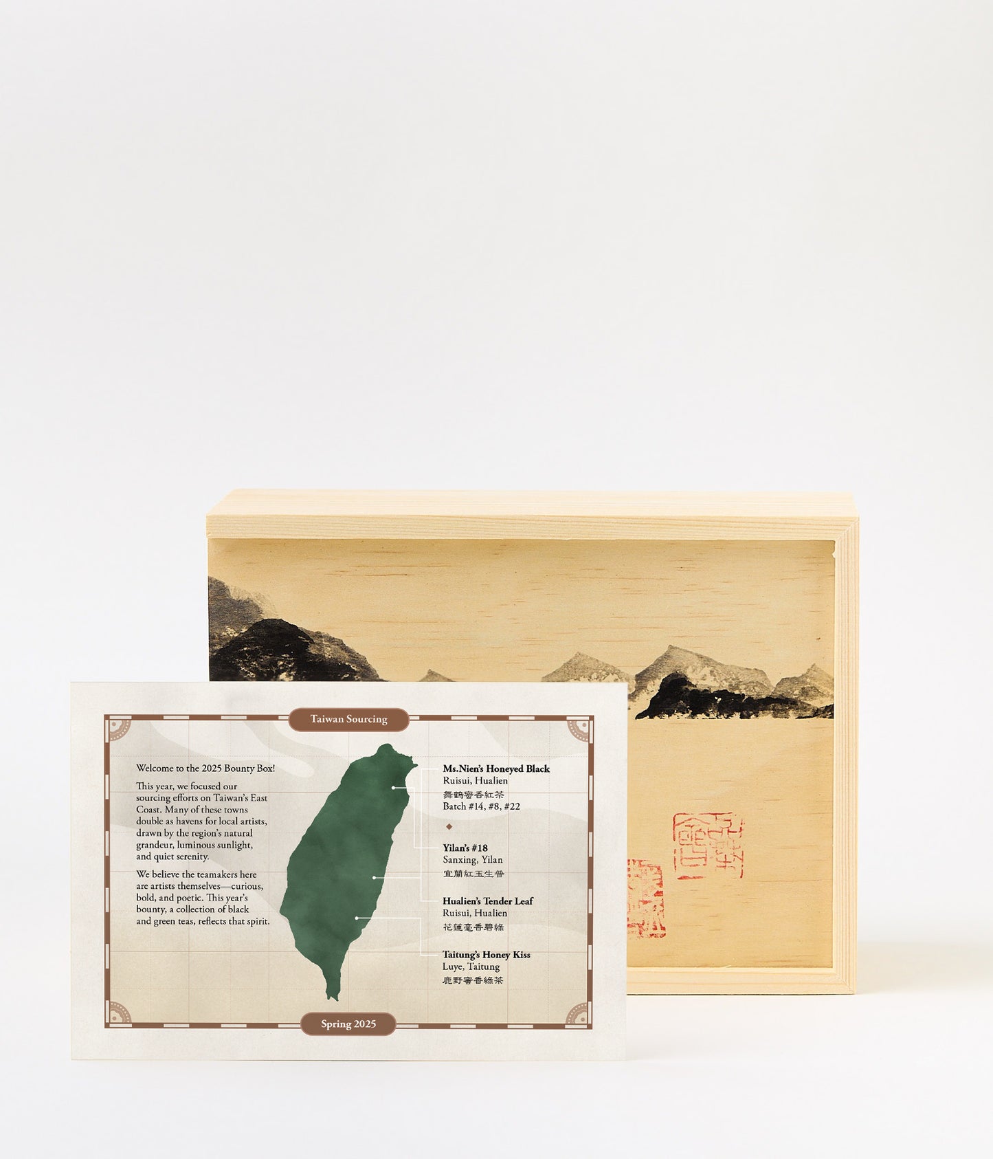 Wooden box with mountains, Chinese stamps and card with tea tasting descriptions.