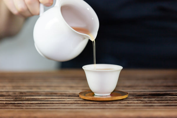 pouring tea into cup