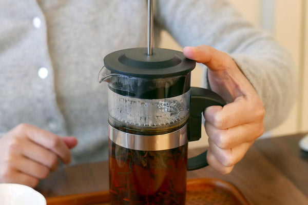 French press with loose leaf tea.