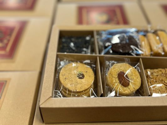 Elegant corporate cookie gift box with assorted wrapped treats.