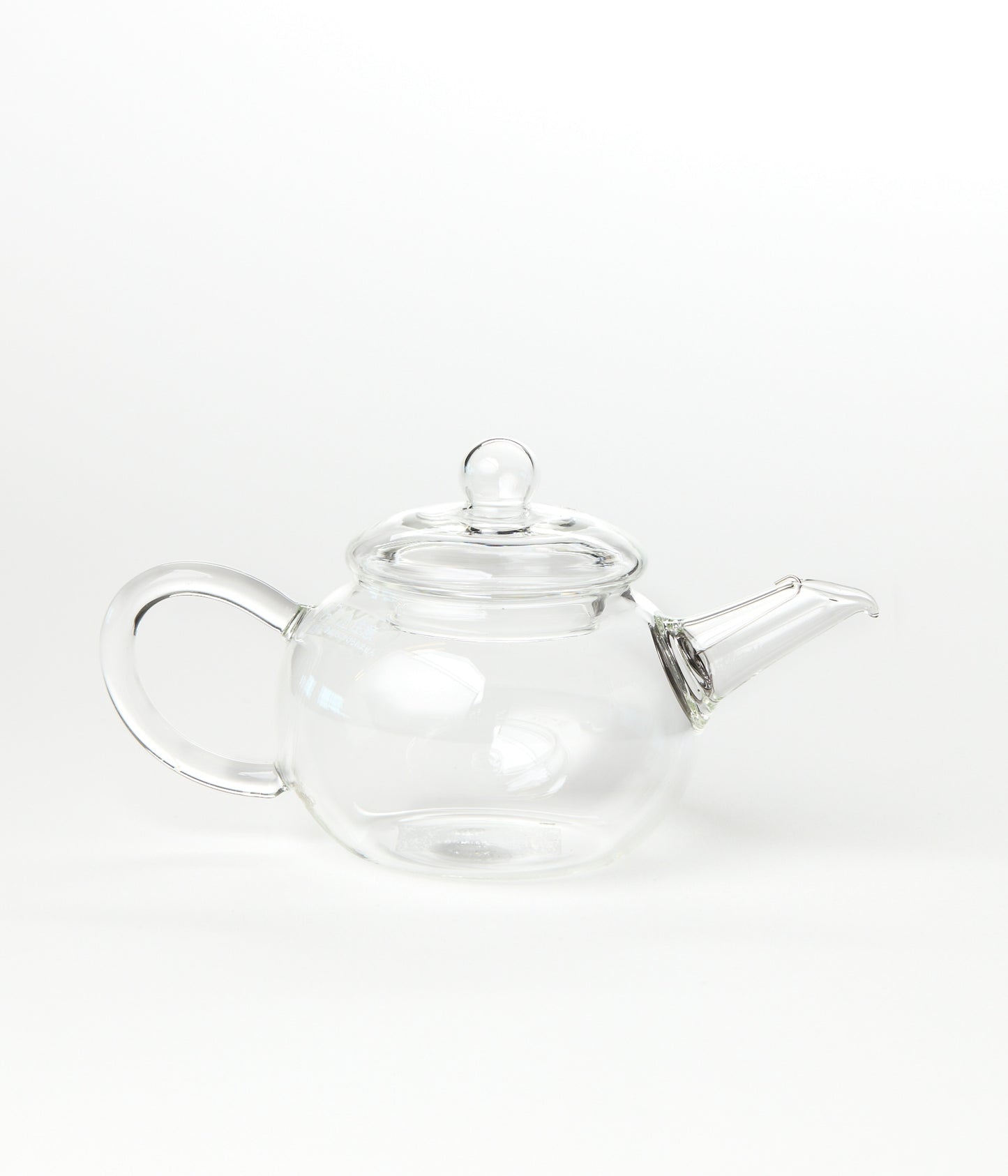 Clear glass teapot on a white background