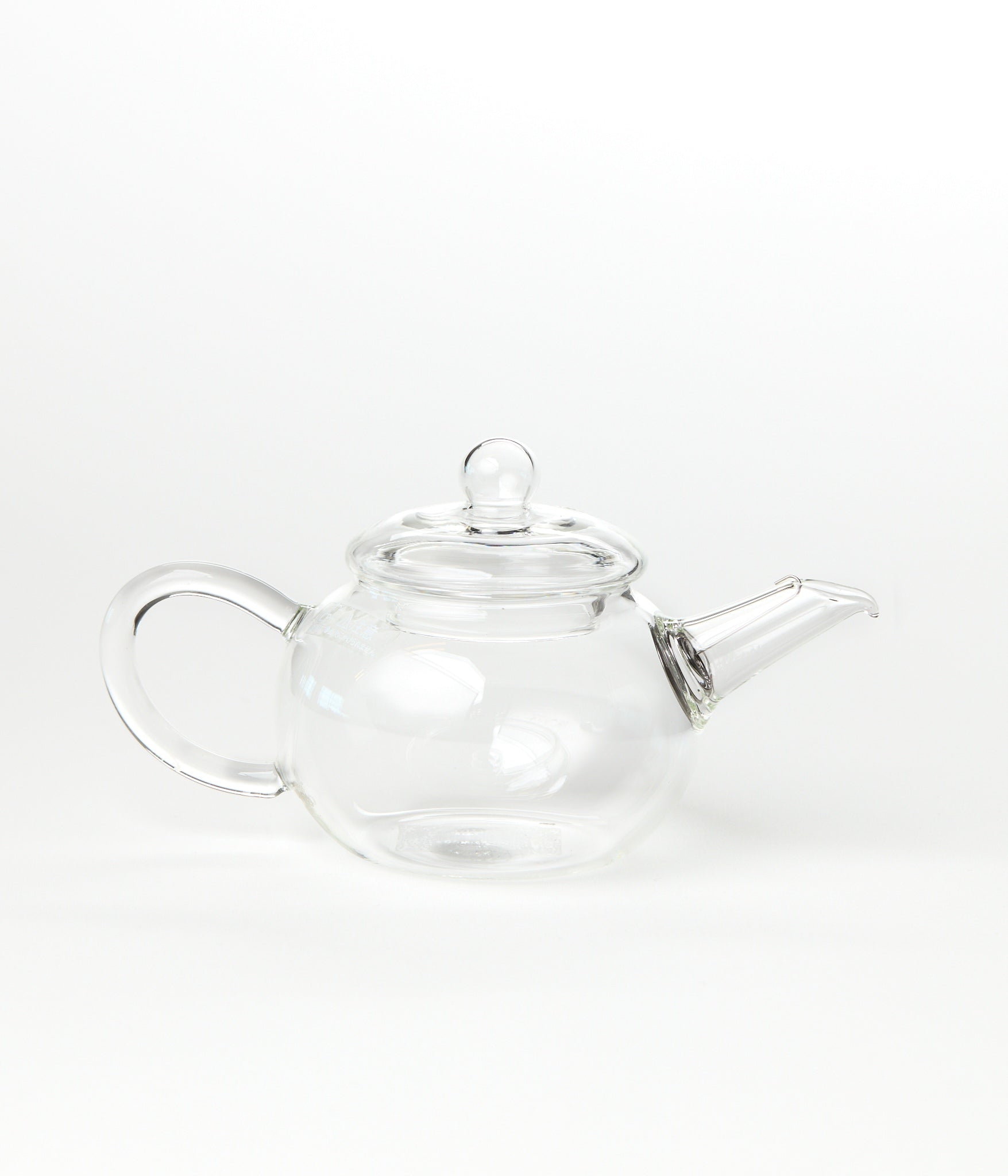 Clear glass teapot on a white background